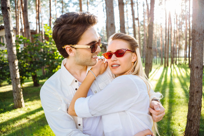 A happy couple in an open marriage embracing each other outdoors, smiling for the camera. A happy couple in an open marriage embracing each other outdoors, smiling for the camera.