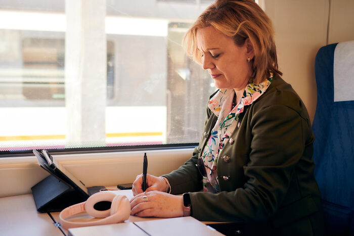 A woman working on a train, preparing to deliver an epic comeback, focused and determined.