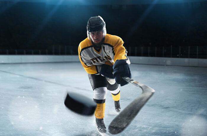 Ice hockey player shooting a puck, preparing for an epic comeback in the game.
