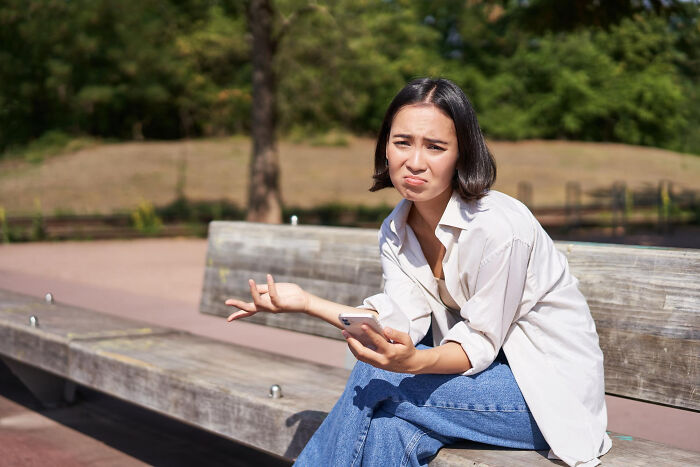 A woman on a park bench looks confused, shrugging her shoulders. Sometimes an epic comeback is needed.
