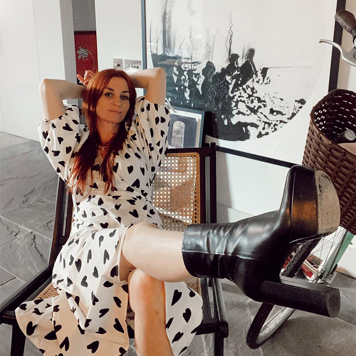 A woman sitting with her legs up, showcasing the resume botoxing trick for job applications.
