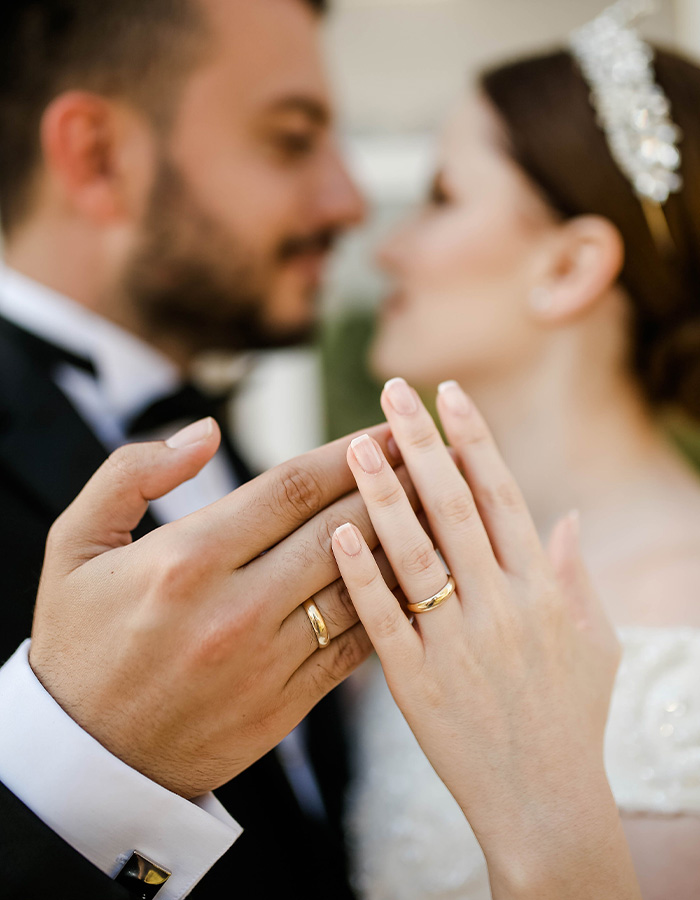 Close-up of a married couple's hands with wedding rings, emphasizing marriage and their bond in their apartment. Close-up of a married couple's hands with wedding rings, emphasizing marriage and their bond in their apartment.