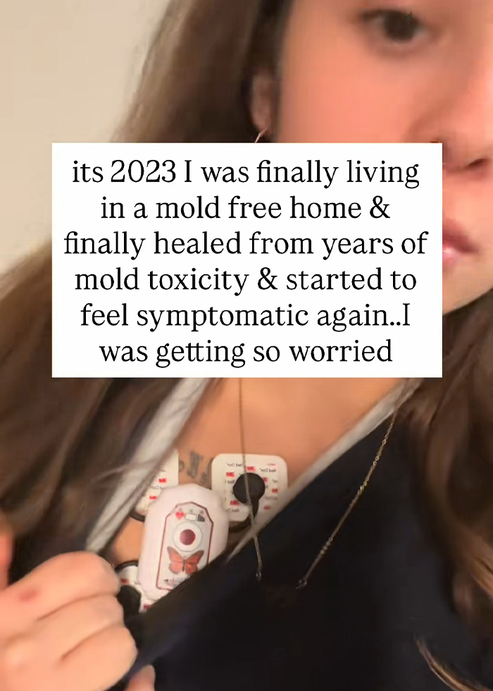 A woman showing medical monitoring devices, worried about becoming symptomatic again in her boyfriend's home. A woman showing medical monitoring devices, worried about becoming symptomatic again in her boyfriend's home.