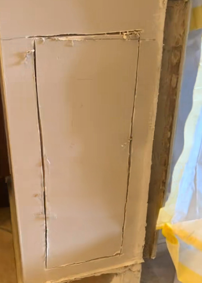 A wall with a section cut out, revealing an opening, suggesting discovery of something causing unexplained symptoms. A wall with a section cut out, revealing an opening, suggesting discovery of something causing unexplained symptoms.