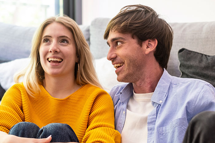 Smiling couple discussing becoming a primary caregiver for an orphaned nephew. Smiling couple discussing becoming a primary caregiver for an orphaned nephew.
