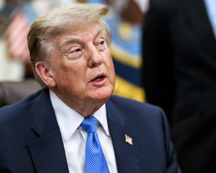 Donald Trump looking thoughtful, a leader often involved in public discourse and reactions to events like vandalism.