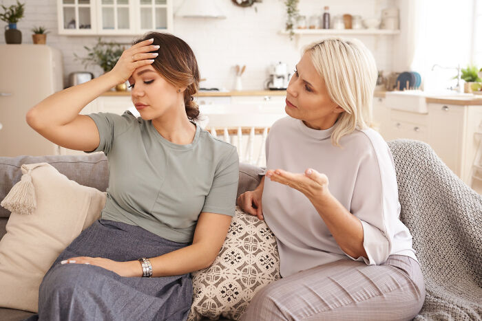 An older woman talking to a younger woman who looks distressed, possibly related to comments from women.