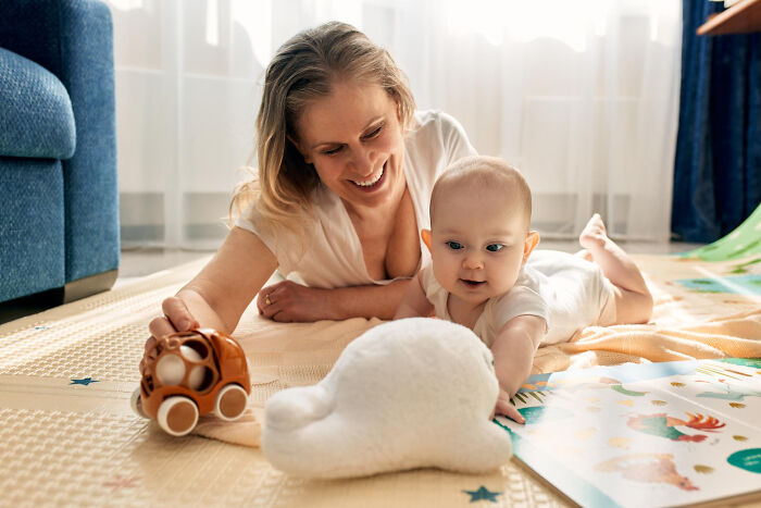 A happy mother playing with her baby, highlighting women's roles and potential escape scenarios.