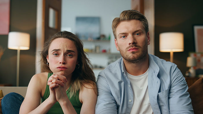 A man and woman looking serious, representing the impact of a guy's affair exposed and other cheaters. A man and woman looking serious, representing the impact of a guy's affair exposed and other cheaters.