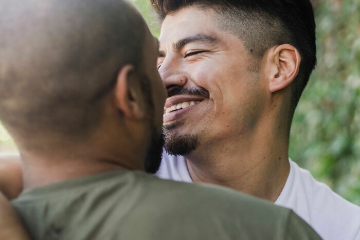 Two men smiling, reflecting on things they put up with before walking away.