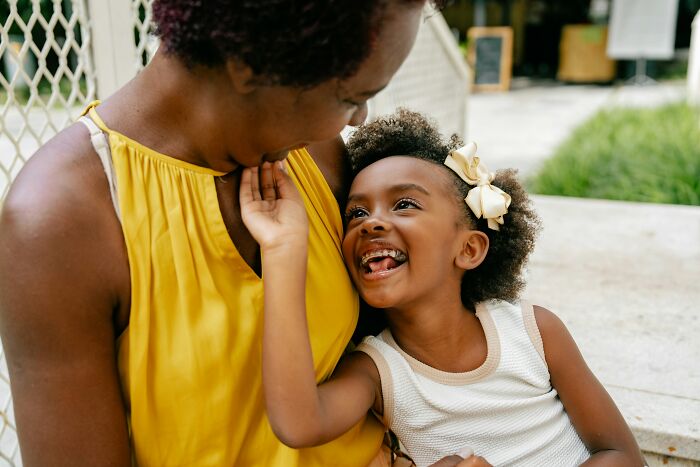 A happy young girl with her mother, perhaps a reminder of a past young and dumb decision.