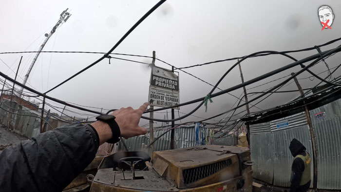 A YouTuber points to a PRIVATE PROPERTY sign in a city above the clouds, highlighting the challenges of exploration.