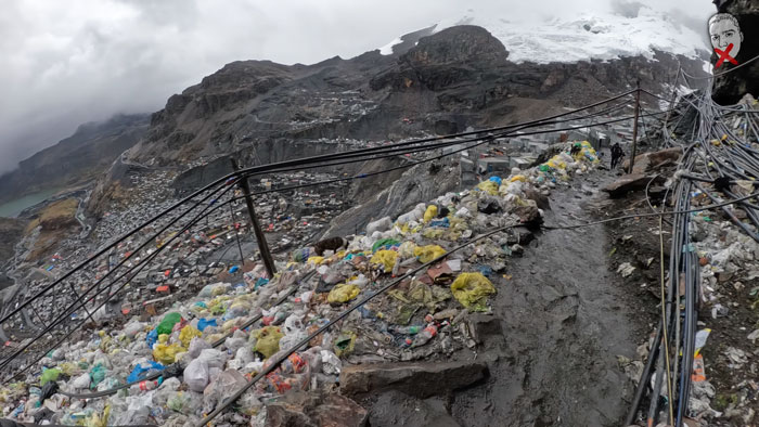 A YouTuber explores a city above the clouds, filled with rubbish and exposed wires, showcasing the crime.