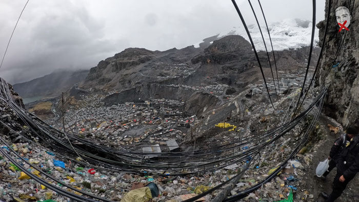 A YouTuber exploring a city above the clouds where crime is visible, with widespread litter and tangled wires.