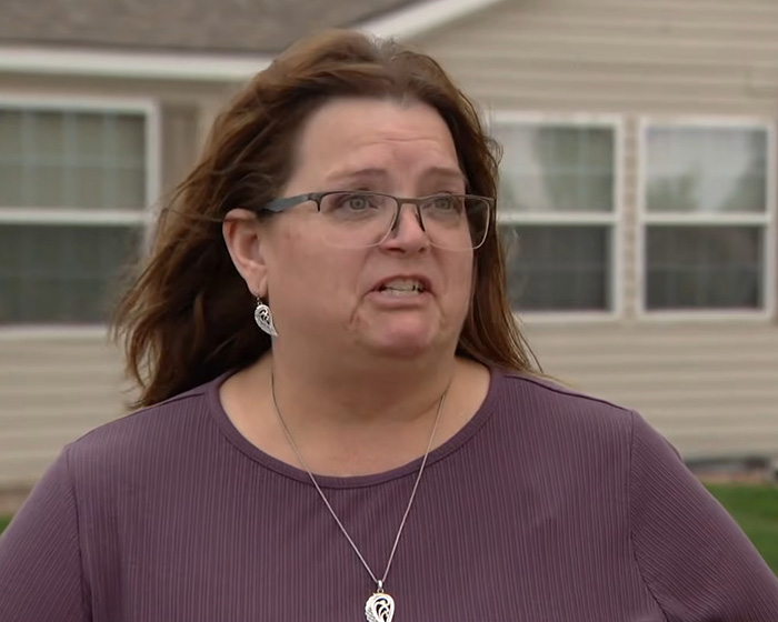 A woman with glasses and a purple shirt, likely related to the viral Zillow listing about removing an occupant. A woman with glasses and a purple shirt, likely related to the viral Zillow listing about removing an occupant.