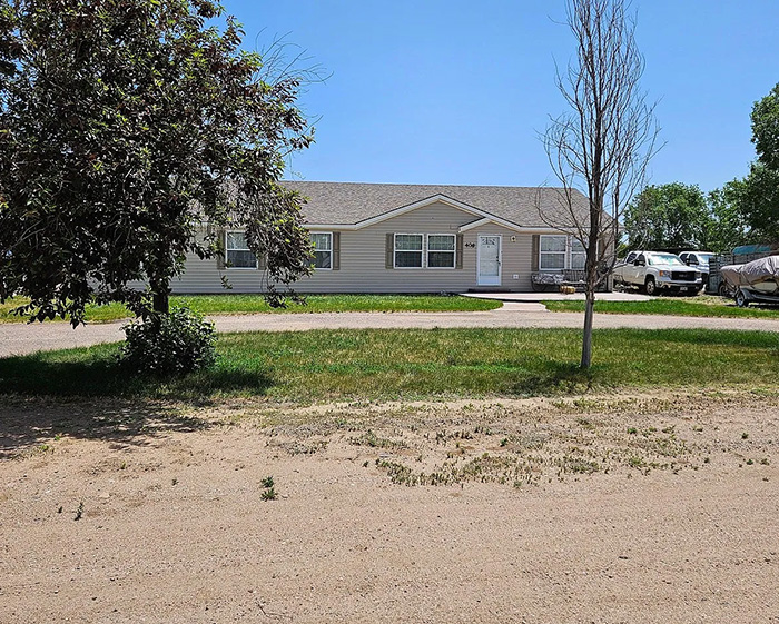 A Zillow listing for a simple house with trees and a dirt driveway, part of the viral listing. A Zillow listing for a simple house with trees and a dirt driveway, part of the viral listing.