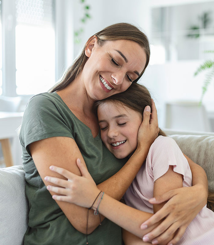 Smiling viral mom embracing her daughter, reflecting a happy family moment after the girls' t-shirt controversy. Smiling viral mom embracing her daughter, reflecting a happy family moment after the girls' t-shirt controversy.