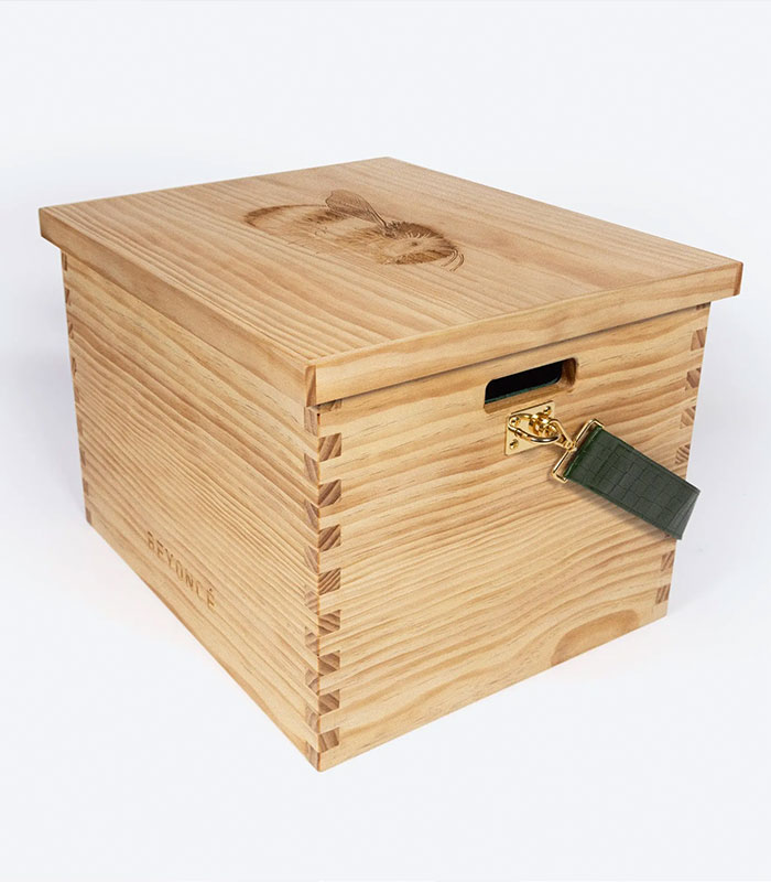 Beyoncé wooden box, a light brown wooden box with an engraved bee on the lid and the word BEYONCE on the side. Beyoncé wooden box, a light brown wooden box with an engraved bee on the lid and the word BEYONCE on the side.