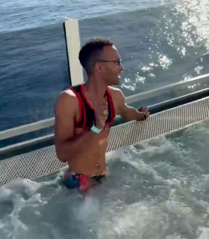 Alleged cruise ticket scammer pastor in a hot tub on a cruise ship, facing scrutiny. Alleged cruise ticket scammer pastor in a hot tub on a cruise ship, facing scrutiny.