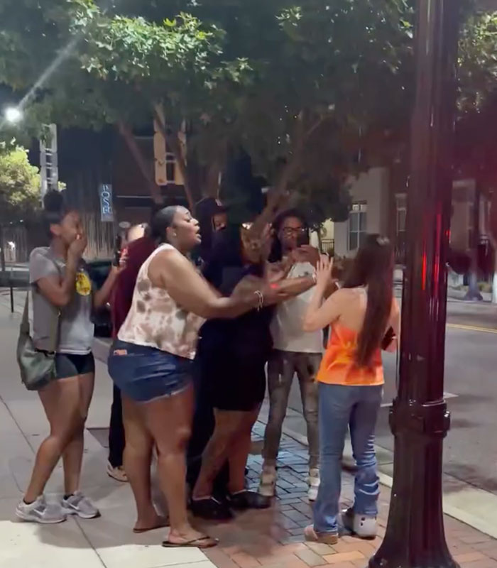 A group of people confronting a woman on the street, highlighting that actions have consequences. A group of people confronting a woman on the street, highlighting that actions have consequences.