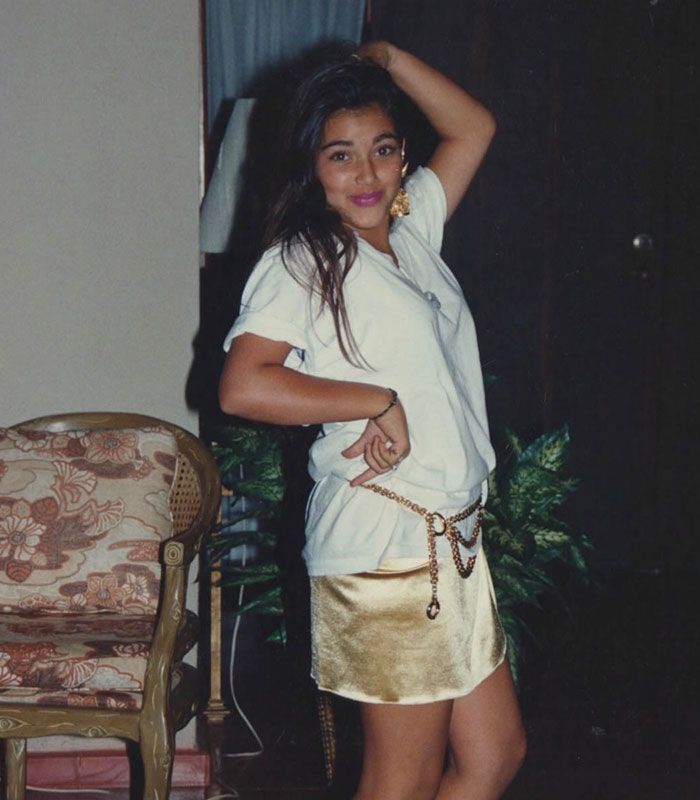 Young Kim Kardashian posing in a white t-shirt and gold skirt, part of a parenting comparison.
