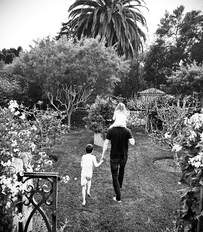 Meghan and Harry with Archie and Lilibet in a black and white photo, amidst school withdrawal.