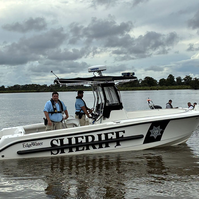 Sheriff officers on a boat, investigating the tragic d***h of Saylor Hayes, with details emerging in the case.