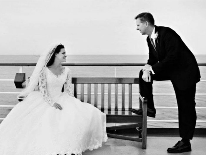 Black and white wedding photo of a couple posing on a cruise ship deck. Black and white wedding photo of a couple posing on a cruise ship deck.
