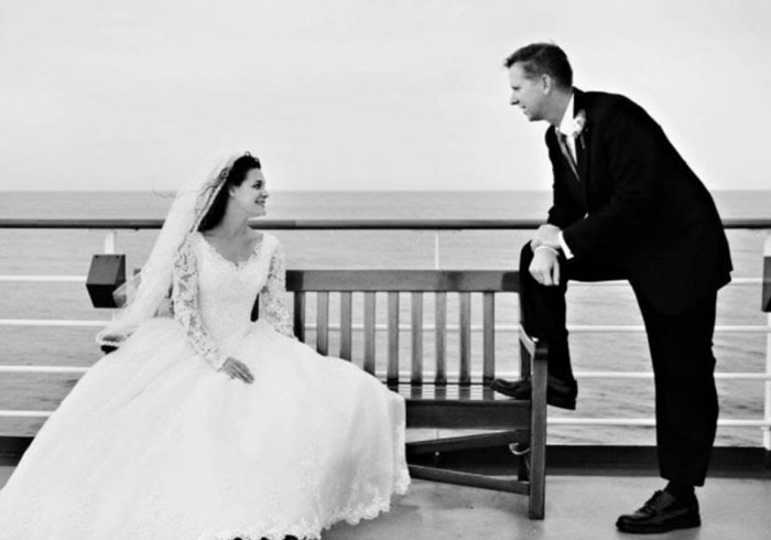 A newlywed couple celebrates their anniversary on the deck of a cruise ship
