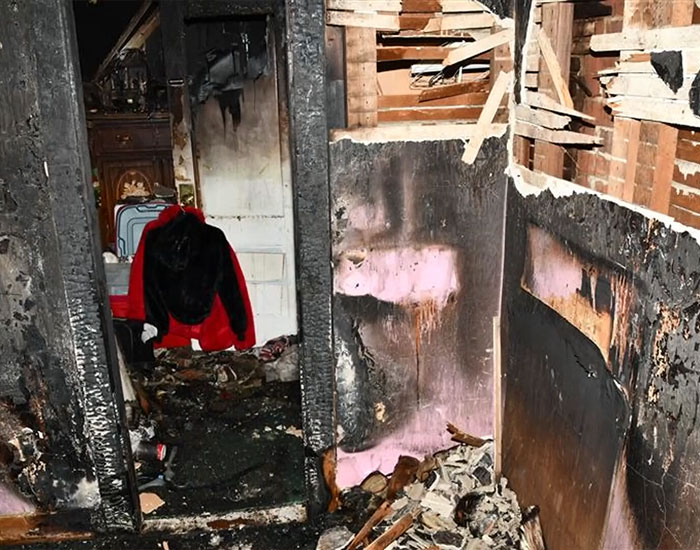 The charred remains of a room inside the house set ablaze by a stepson held captive. The charred remains of a room inside the house set ablaze by a stepson held captive.