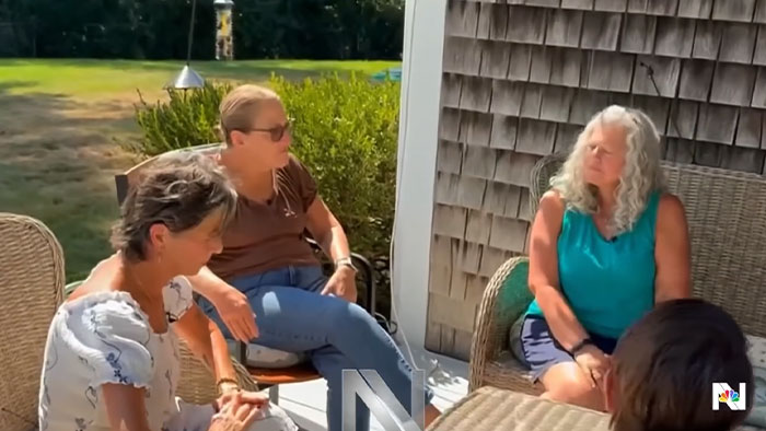 Three women, including a Lindsay Clancy juror, sit on a sunny outdoor patio, engaged in a serious discussion about the verdict chaos. Three women, including a Lindsay Clancy juror, sit on a sunny outdoor patio, engaged in a serious discussion about the verdict chaos.