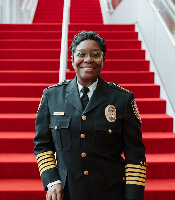 Police Chief Patrice Andrews posing in uniform, relevant to the woman hurling N-word incident consequences. Police Chief Patrice Andrews posing in uniform, relevant to the woman hurling N-word incident consequences.