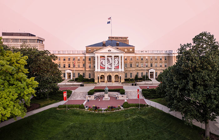 University building with flags and green lawn, representing campus University building with flags and green lawn, representing campus
