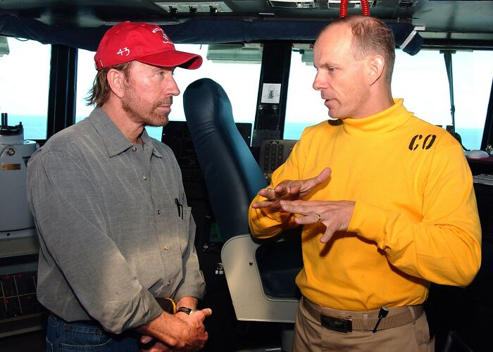 Chuck Norris, a once-admired public figure, talks to another man, potentially destroying his legacy.