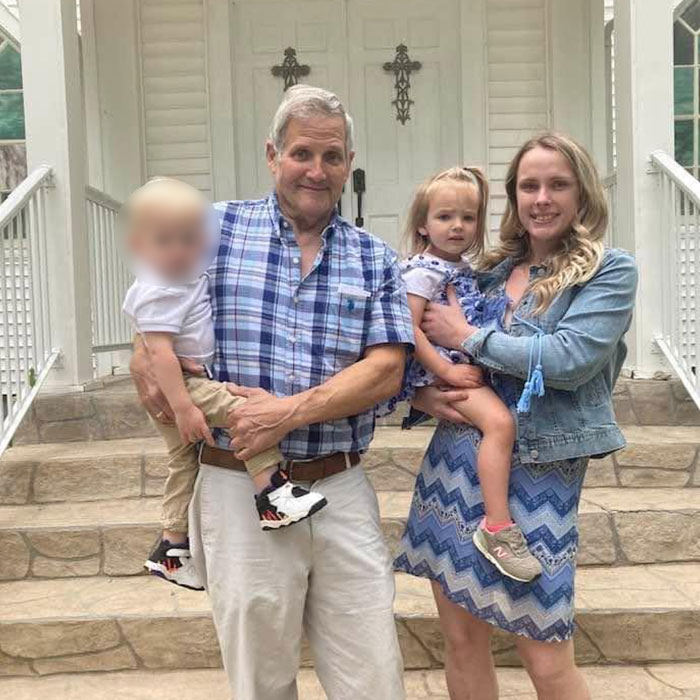 Saylor Hayes family: Parents and two young children, including 5YO Saylor Hayes, in front of a white building.