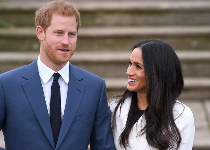 Harry and Meghan smiling, looking at each other, as William and Kate plan for their UK return. Harry and Meghan smiling, looking at each other, as William and Kate plan for their UK return.