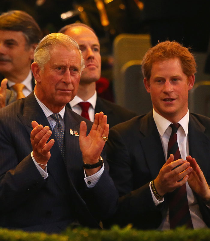 Prince Charles and Prince Harry clapping, relating to the Meghan and Harry story.