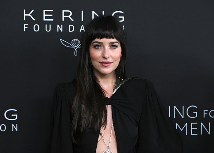 Hollywood actress Dakota Johnson, at an event, known for her intimate scenes confessions.