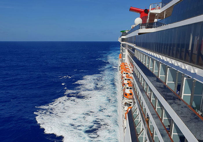 Side view of a large cruise ship sailing in the blue ocean