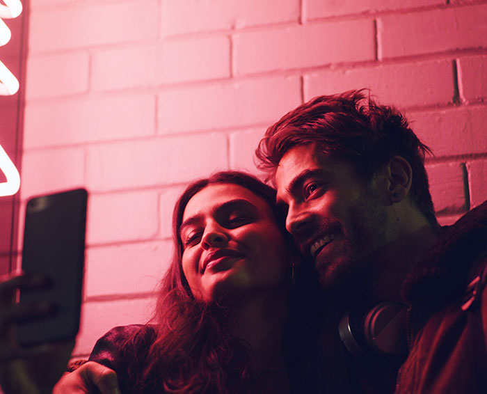 A happy young couple taking a selfie, avoiding common dating mistakes. A happy young couple taking a selfie, avoiding common dating mistakes.