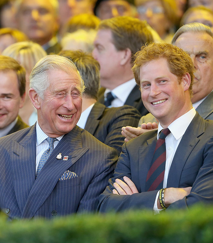 Prince Charles and Prince Harry laughing, relating to the Meghan and Harry story.