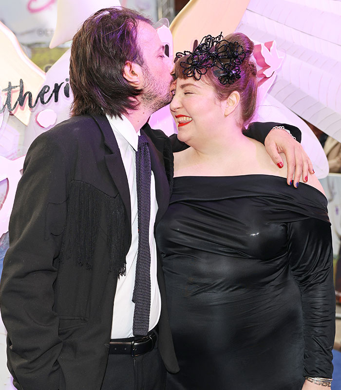 Lena Dunham with a partner, who is kissing her forehead, after welcoming a baby via surrogate. Lena Dunham with a partner, who is kissing her forehead, after welcoming a baby via surrogate.