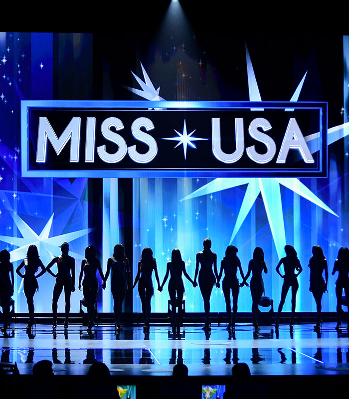 A group of contestants stands on stage during a Universal Woman pageant, sparking outrage. A group of contestants stands on stage during a Universal Woman pageant, sparking outrage.