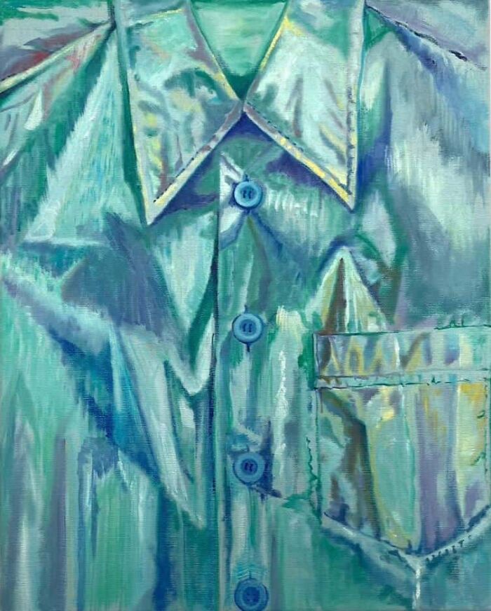 A metallic green-blue shirt with a shiny texture, showcasing striking portraits of identity through fabric art.