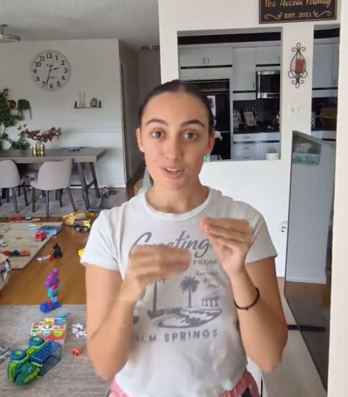 A woman with autism and ADHD in a casual setting, gesturing while discussing her choice not to work.