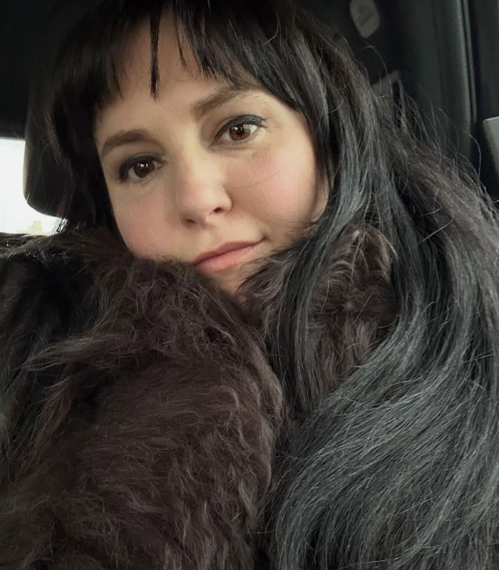 Lena Dunham with long dark hair, wearing a fur collar, facing furious backlash for welcoming a baby via surrogate. Lena Dunham with long dark hair, wearing a fur collar, facing furious backlash for welcoming a baby via surrogate.