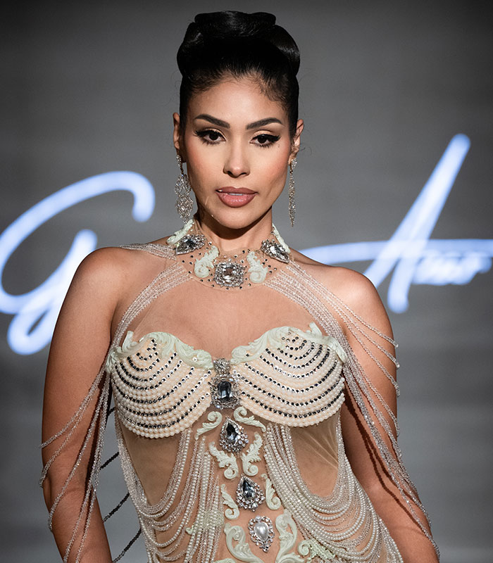 A contestant in an elaborate gown at a Universal Woman pageant, generating contest outrage. A contestant in an elaborate gown at a Universal Woman pageant, generating contest outrage.