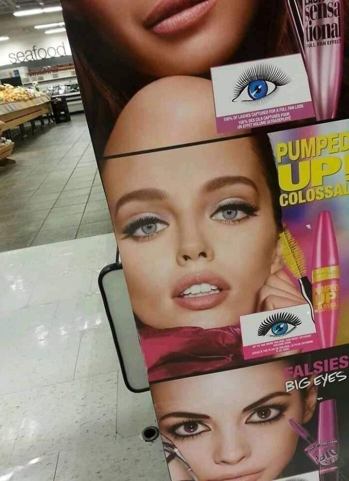 A makeup advertisement display in a store showing a model with a confusing perspective, looking like she is bald.