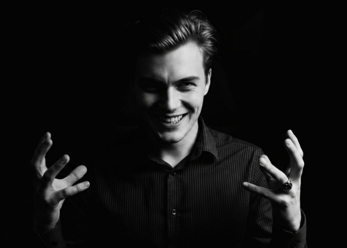 A man with a wide grin and hands raised, symbolizing a dangerous personality type beyond psychopaths. A man with a wide grin and hands raised, symbolizing a dangerous personality type beyond psychopaths.