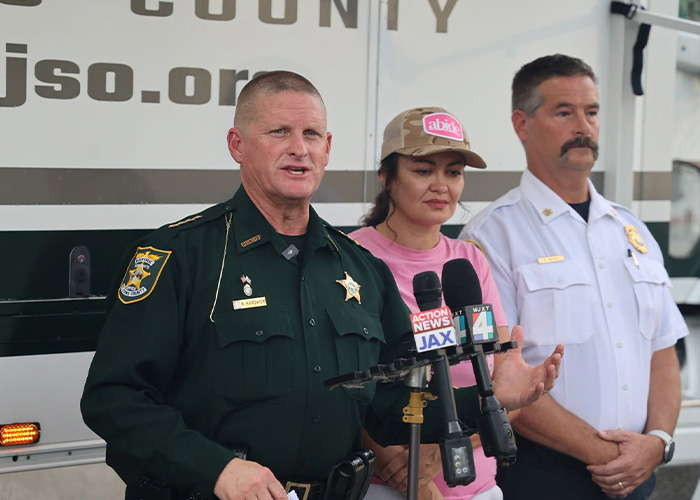 A mom, sheriff, and fire chief at a press conference where missing son was found live.